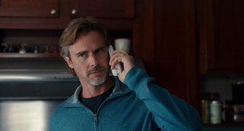 Movie still from “The Fault in Our Stars” (2014), directed by Josh Boone – A man holding a nintendo wii controller while talking on the phone; Close Up shot, Low angle