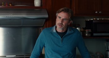 Movie still from “The Fault in Our Stars” (2014), directed by Josh Boone – A person wearing a sweater in a kitchen; Close Up shot, Over the shoulder angle