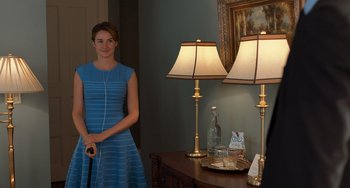 Movie still from “The Fault in Our Stars” (2014), directed by Josh Boone – A woman in a blue dress standing in front of two lamps; Medium shot, Over the shoulder angle