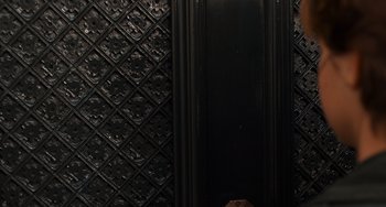 Movie still from “The Fault in Our Stars” (2014), directed by Josh Boone – A black door with a diamond pattern on the wall; Extreme Close Up shot, Overhead angle