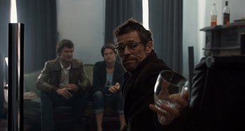 Movie still from “The Fault in Our Stars” (2014), directed by Josh Boone – A man holding a wine glass in front of a group of people; Medium shot, Over the shoulder angle