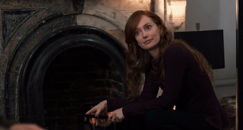 Movie still from “The Fault in Our Stars” (2014), directed by Josh Boone – A woman sitting in front of a fire place; Medium shot, Over the shoulder angle