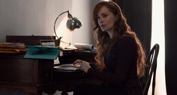 Movie still from “The Fault in Our Stars” (2014), directed by Josh Boone – A woman sitting at a desk using a laptop computer; Medium shot, High angle