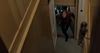 Movie still from “The Fault in Our Stars” (2014), directed by Josh Boone – A woman standing in a doorway looking at the camera; Wide shot, High angle
