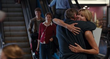 Movie still from “The Fault in Our Stars” (2014), directed by Josh Boone – A man and a woman hugging on a escalator; Medium shot, Over the shoulder angle