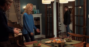 Movie still from “The Fault in Our Stars” (2014), directed by Josh Boone – Two people standing in a dining room near a table; Medium shot, Over the shoulder angle
