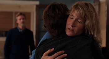 Movie still from “The Fault in Our Stars” (2014), directed by Josh Boone – Two people hugging each other in a living room; Close Up shot, Over the shoulder angle