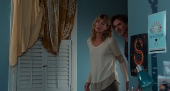 Movie still from “The Fault in Our Stars” (2014), directed by Josh Boone – A man and a woman standing next to each other in a room; Medium shot, Low angle