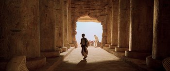 Movie still from “The Fifth Element” (1997), directed by Luc Besson – A man walking through an archway in an egyptian temple; Extreme Wide shot, Low angle