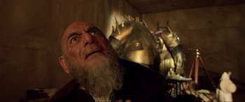 Movie still from “The Fifth Element” (1997), directed by Luc Besson – An old man with a long white beard looking up; Close Up shot, Low angle