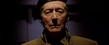 Movie still from “The Fifth Element” (1997), directed by Luc Besson – An older man wearing a military uniform and headphones; Close Up shot, Low angle