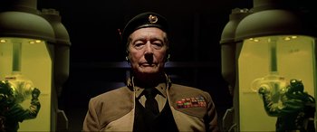 Movie still from “The Fifth Element” (1997), directed by Luc Besson – An older man wearing a military uniform and wearing a hat; Close Up shot, Low angle