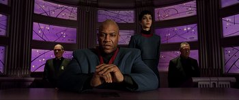 Movie still from “The Fifth Element” (1997), directed by Luc Besson – A man and a woman are sitting at a table; Medium shot, Low angle