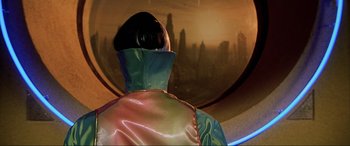 Movie still from “The Fifth Element” (1997), directed by Luc Besson – A person wearing a cape looking out at a city skyline; Medium shot, Low angle