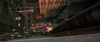 Movie still from “The Fifth Element” (1997), directed by Luc Besson – A view from above of a train station with lights; Extreme Wide shot, Overhead angle