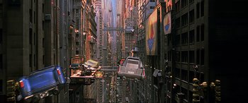 Movie still from “The Fifth Element” (1997), directed by Luc Besson – An image of a car flying through the air in a city; Extreme Wide shot, High angle