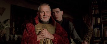 Movie still from “The Fifth Element” (1997), directed by Luc Besson – A man and a boy dressed in medieval garb; Close Up shot, Low angle