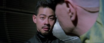 Movie still from “The Fifth Element” (1997), directed by Luc Besson – A man is taking a picture of another man's face; Close Up shot, Over the shoulder angle