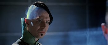 Movie still from “The Fifth Element” (1997), directed by Luc Besson – A person with a bandage on his head; Close Up shot, Over the shoulder angle