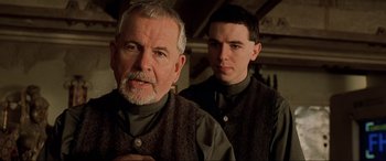 Movie still from “The Fifth Element” (1997), directed by Luc Besson – A man and a boy standing next to each other; Close Up shot, Low angle