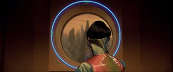 Movie still from “The Fifth Element” (1997), directed by Luc Besson – A man in a red jacket looking out a window; Medium shot, Over the shoulder angle