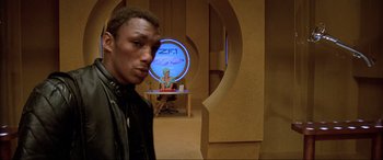 Movie still from “The Fifth Element” (1997), directed by Luc Besson – A man standing in front of a computer screen; Medium shot, Over the shoulder angle