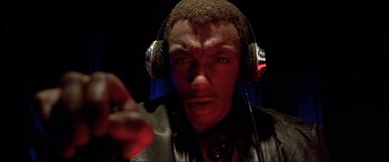 Movie still from “The Fifth Element” (1997), directed by Luc Besson – A man wearing headphones and a leather jacket; Close Up shot, Low angle