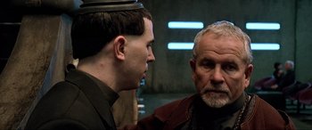 Movie still from “The Fifth Element” (1997), directed by Luc Besson – A man and a man with a hat on; Close Up shot, Over the shoulder angle