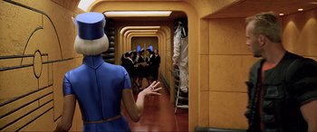 Movie still from “The Fifth Element” (1997), directed by Luc Besson – A group of people standing in a room; Wide shot, Over the shoulder angle