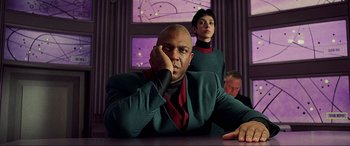 Movie still from “The Fifth Element” (1997), directed by Luc Besson – A man and a woman sitting at a table; Medium shot, Low angle