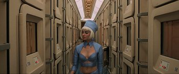 Movie still from “The Fifth Element” (1997), directed by Luc Besson – A woman in a blue outfit standing in a hallway; Medium shot, Overhead angle