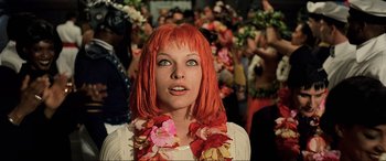Movie still from “The Fifth Element” (1997), directed by Luc Besson – A woman with red hair wearing a flower lei; Close Up shot, Low angle