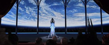 Movie still from “The Fifth Element” (1997), directed by Luc Besson – A woman standing on a stage in front of an audience; Wide shot, Low angle