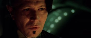 Movie still from “The Fifth Element” (1997), directed by Luc Besson – A man's face in the dark; Close Up shot, Low angle