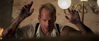 Movie still from “The Fifth Element” (1997), directed by Luc Besson – A person holding their hands up; Close Up shot, Low angle