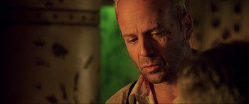 Movie still from “The Fifth Element” (1997), directed by Luc Besson – A bald man with a beard is looking at the camera; Close Up shot, Low angle