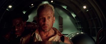 Movie still from “The Fifth Element” (1997), directed by Luc Besson – A man with a knife in his mouth and a cell phone in his other hand; Close Up shot, Low angle