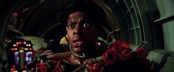 Movie still from “The Fifth Element” (1997), directed by Luc Besson – A person wearing a costume; Close Up shot, Low angle