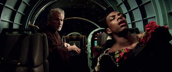 Movie still from “The Fifth Element” (1997), directed by Luc Besson – A man and a woman are standing in a room; Close Up shot, Low angle