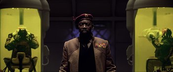 Movie still from “The Fifth Element” (1997), directed by Luc Besson – A man wearing a military uniform and a hat; Close Up shot, Low angle