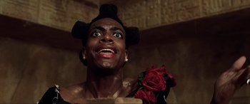 Movie still from “The Fifth Element” (1997), directed by Luc Besson – A man with a bunch of roses on his shoulder; Close Up shot, Low angle