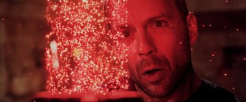 Movie still from “The Fifth Element” (1997), directed by Luc Besson – A man's face with red lights in the background; Close Up shot, Overhead angle