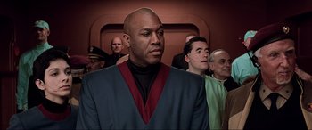 Movie still from “The Fifth Element” (1997), directed by Luc Besson – A group of men standing next to each other in a room; Medium shot, Low angle