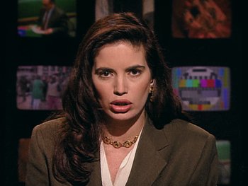 Movie still from “The Figo Affair: The Transfer that Changed Football” (2022), directed by Ben Nicholas – A woman with long dark brown hair wearing a brown jacket; Close Up shot, High angle