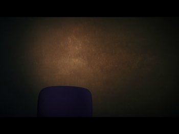 Movie still from “The Figo Affair: The Transfer that Changed Football” (2022), directed by Ben Nicholas – A chair in a room with a brown wall; Medium shot, Low angle