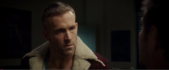 Movie still from “Deadpool” (2016), directed by Tim Miller – A person wearing a jacket; Close Up shot, Over the shoulder angle