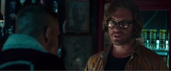 Movie still from “Deadpool” (2016), directed by Tim Miller – A man wearing glasses talking to another man in a room; Close Up shot, Over the shoulder angle