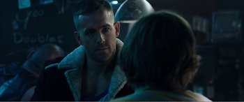 Movie still from “Deadpool” (2016), directed by Tim Miller – A man in a shearling jacket talking to a woman in front of a mirror; Close Up shot, Over the shoulder angle
