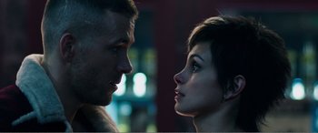 Movie still from “Deadpool” (2016), directed by Tim Miller – A man and a woman face to face in front of a building; Close Up shot, Low angle