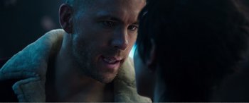 Movie still from “Deadpool” (2016), directed by Tim Miller – A man's face as a woman looks on; Close Up shot, Over the shoulder angle